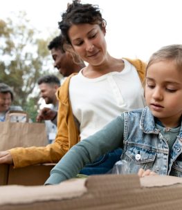 medium-shot-volunteers-with-donations_23-2149182022